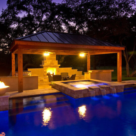 Modern Pool at Night with spillway water feature