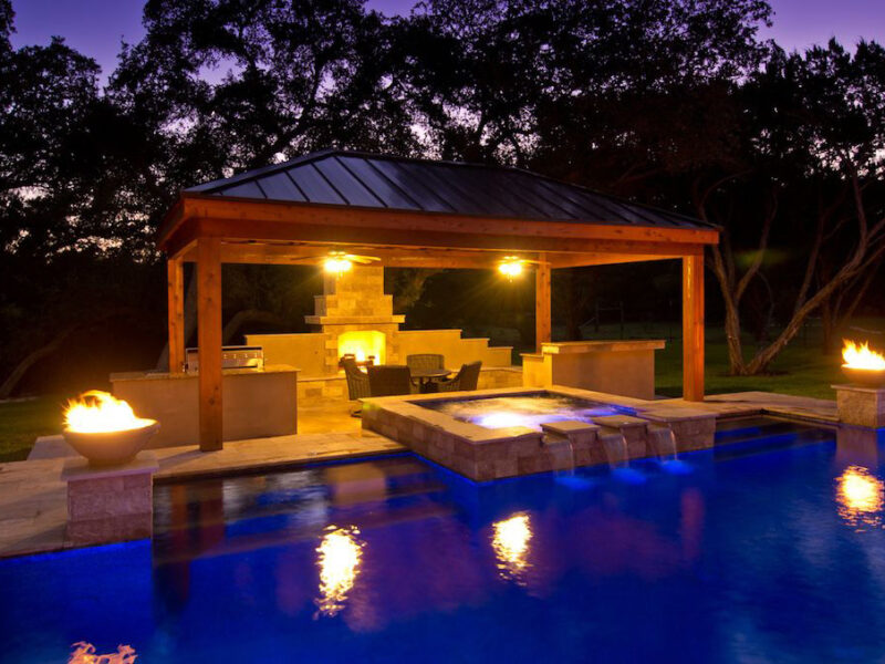 Modern Pool at Night with spillway water feature