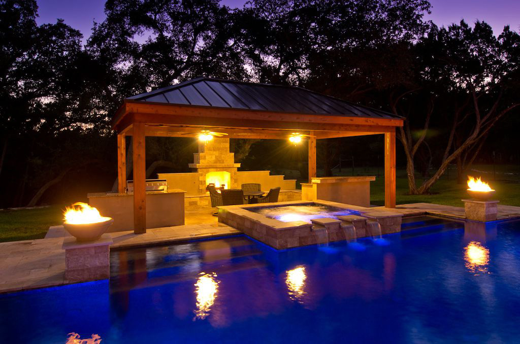 Modern Pool at Night with spillway water feature